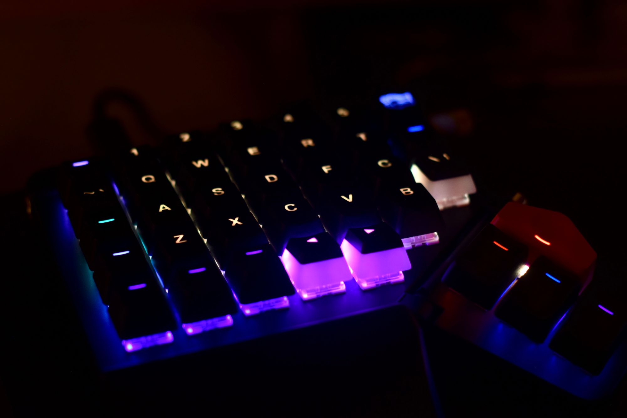 Image of Moonlander keyboard's left side, with backlit keys illuminated